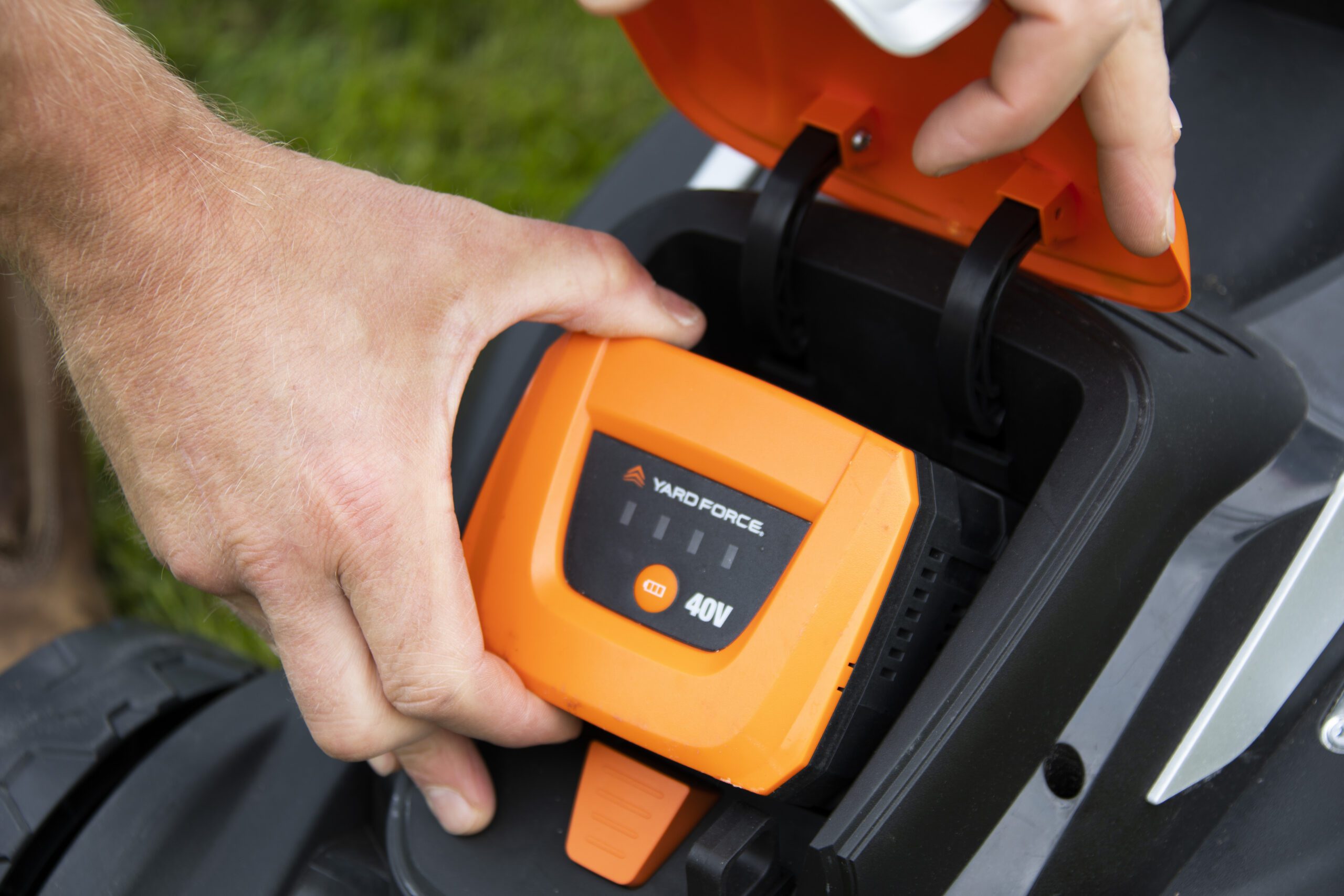 Battery being inserted into a cordless lawn mower!